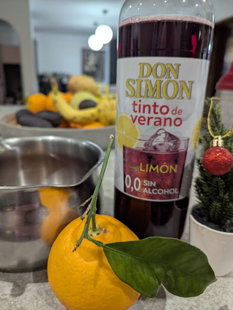 ingredients for alcohol free mulled wine tinto de verano oranges with a saucepan
