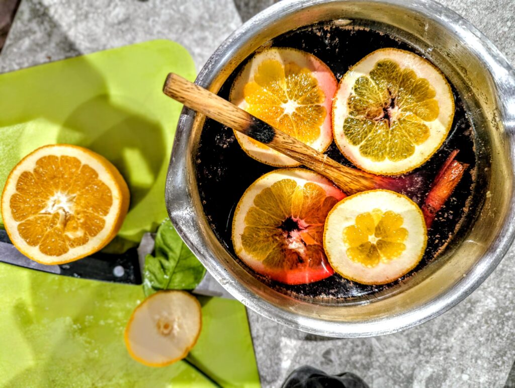 zero alcohol mulled wine in a sauce pan with lemon and orange slices alcohol free festive fun