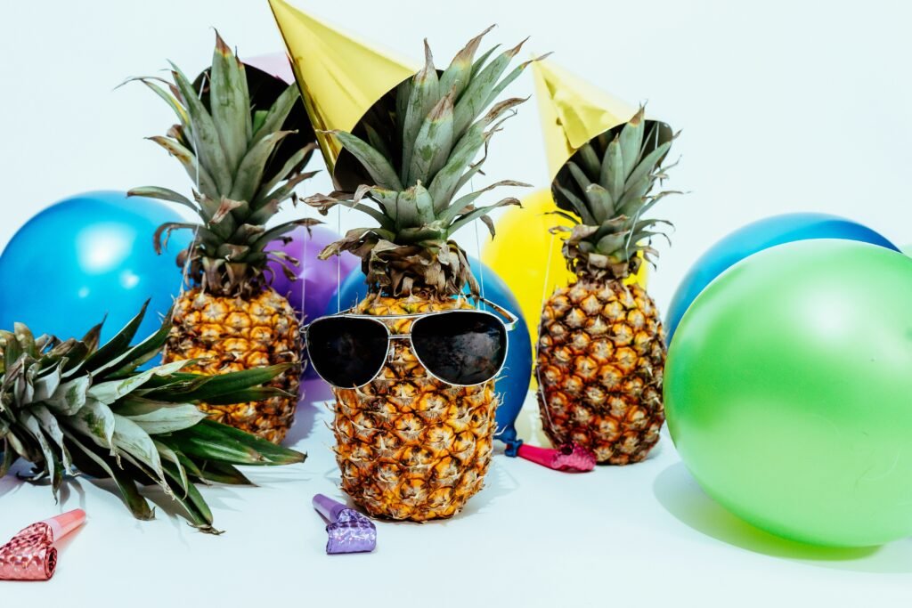 pineapples with summer fun balloons and hats
